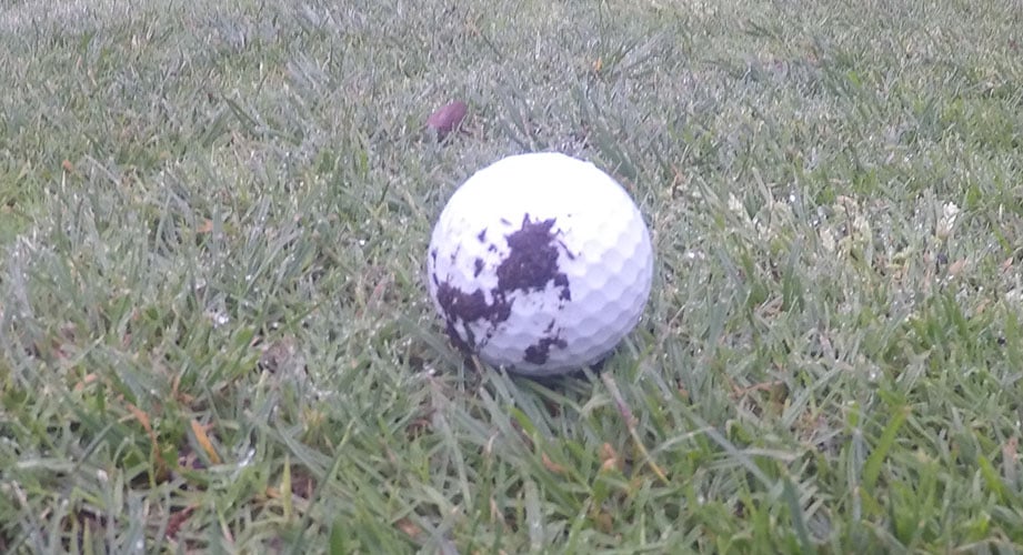 How do you hit a golf ball with mud on it?